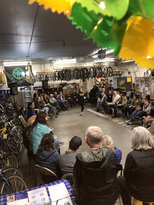 FANCE party at the Bike Library Folks in a circle at the Bike Library discussing important Iowa City topics.